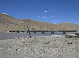 Tibet Kailash 04 Saga to Kailash 03 Bridge Across Yarlung Tsangpo We crossed the Yarlung Tsangpo via the new bridge, just 3km from Saga (4600m). The old double-pontooned ferry used to run along a cable fixed in the crotch of two crossed timbers on either side of the river.